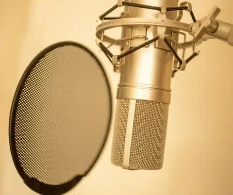 Top Reasons to Start a Podcast and How to Do It in 9 Simple Steps 1 Web Design Image Start a podcast studio setup with microphone and headphones